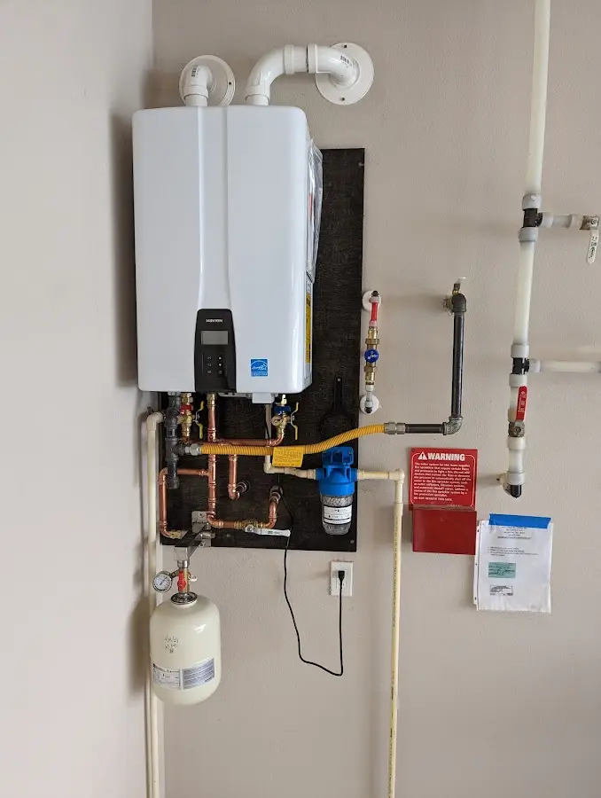 Professional plumber installing copper piping in a West Linn home